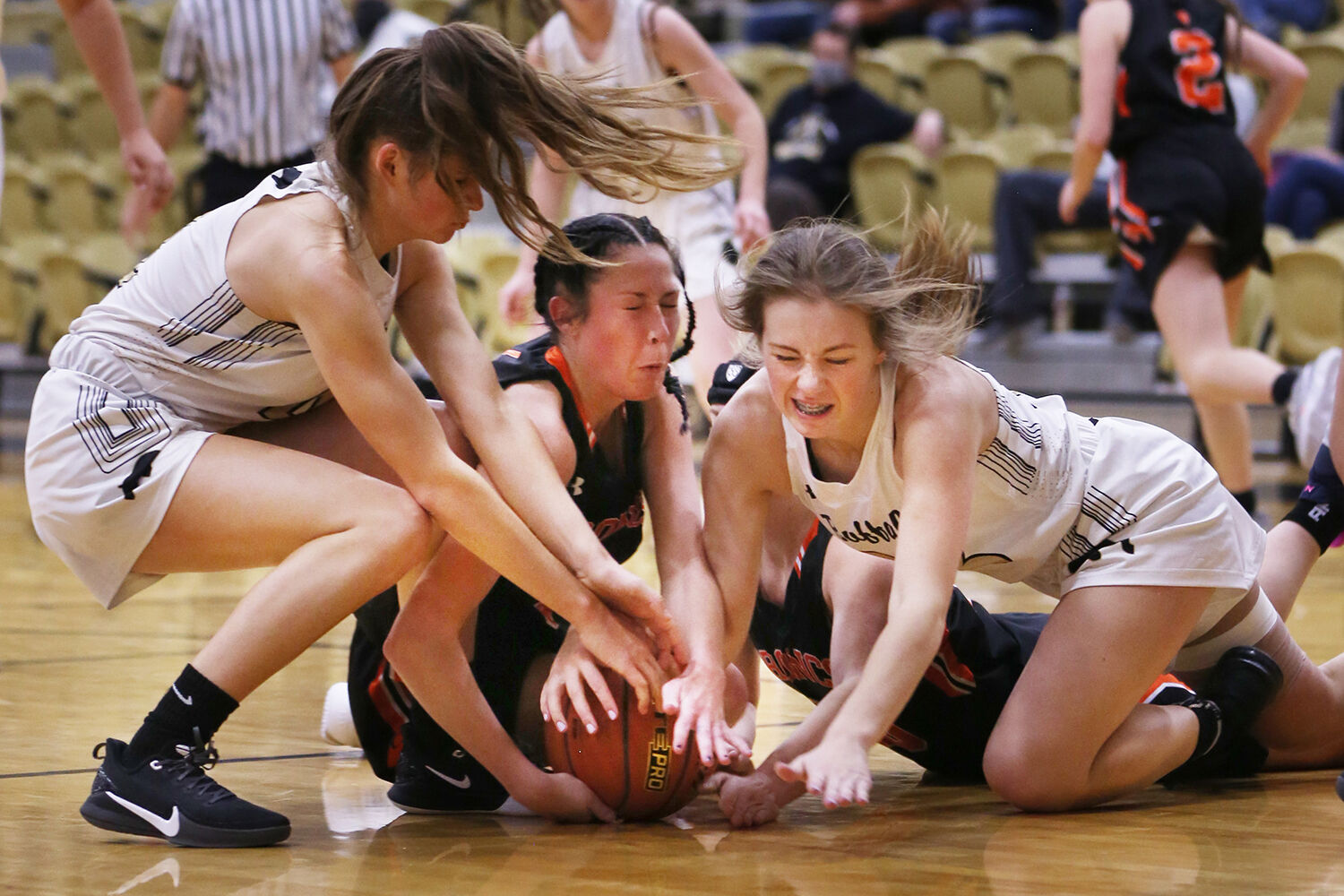 Ava Wagner, right, and junior Lexi Rule dive to retrieve a ball